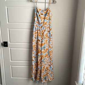 NWT. Mustard and blue print floral open tie back wide leg jumpsuit.
